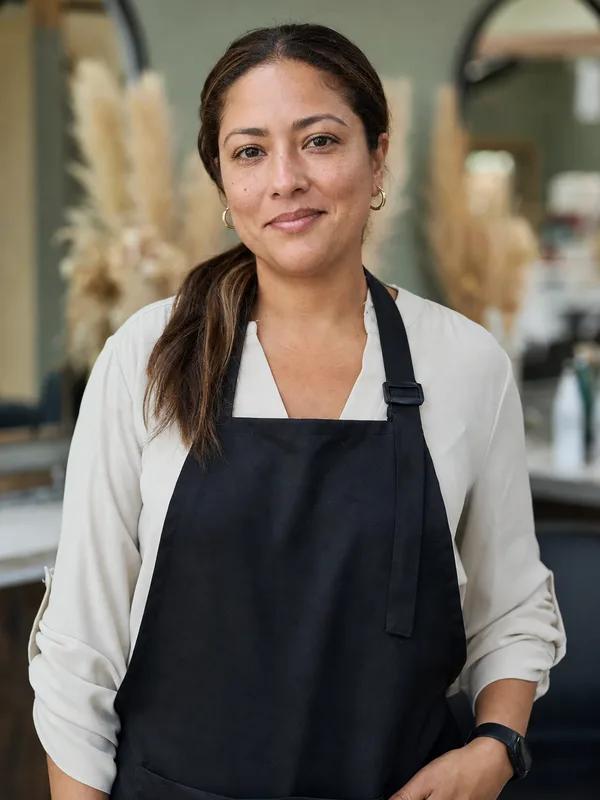 Maria Rodriguez, owner of Bella Hair Studio in Houston, standing in her salon